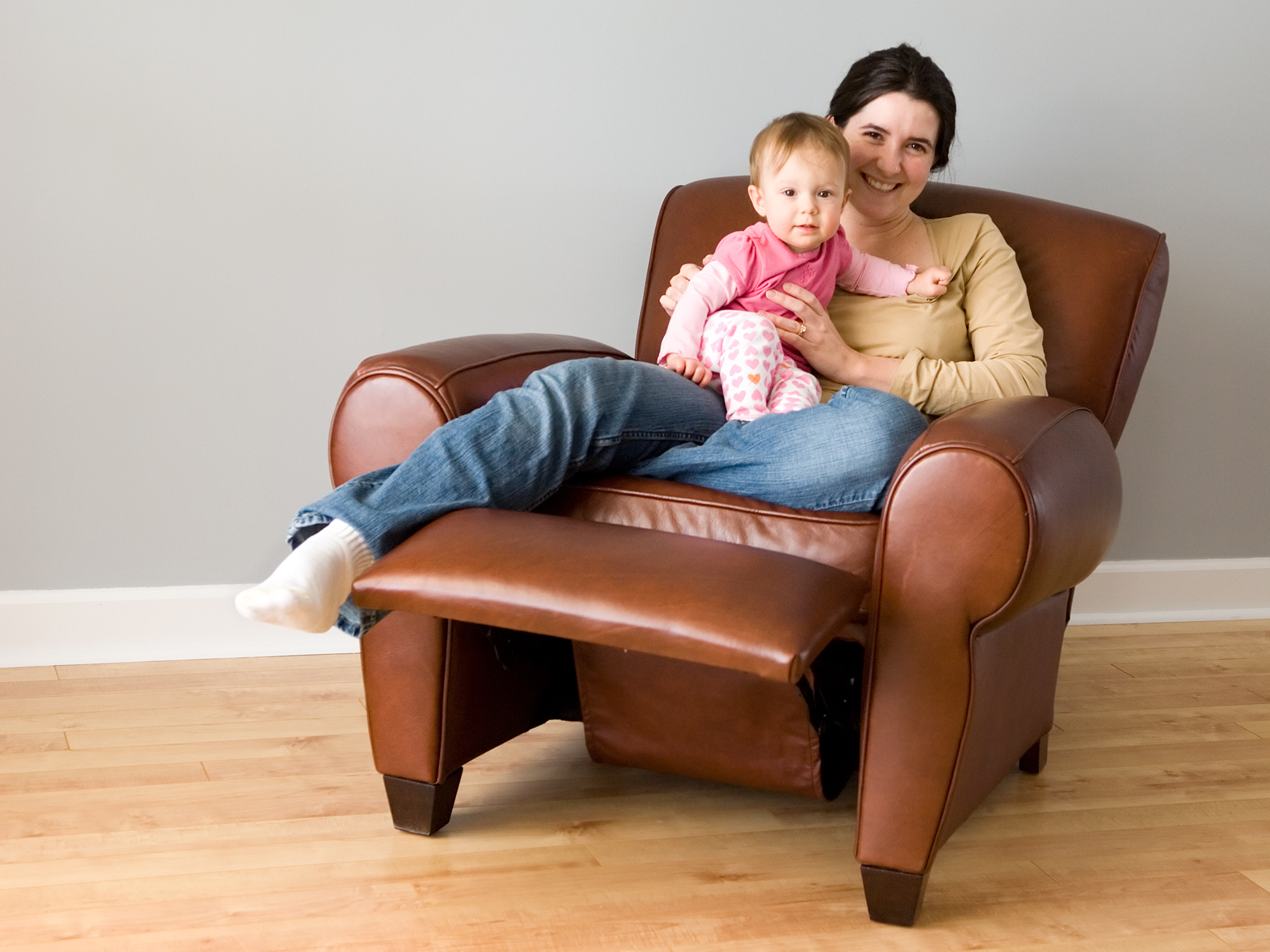 mother and child sitting in a recliner