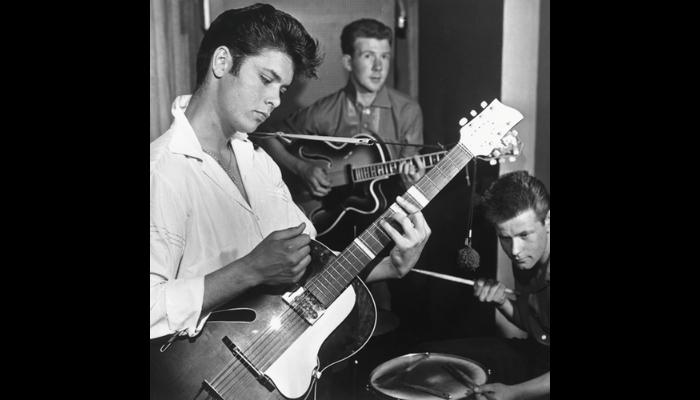 Elvis strumming his guitar