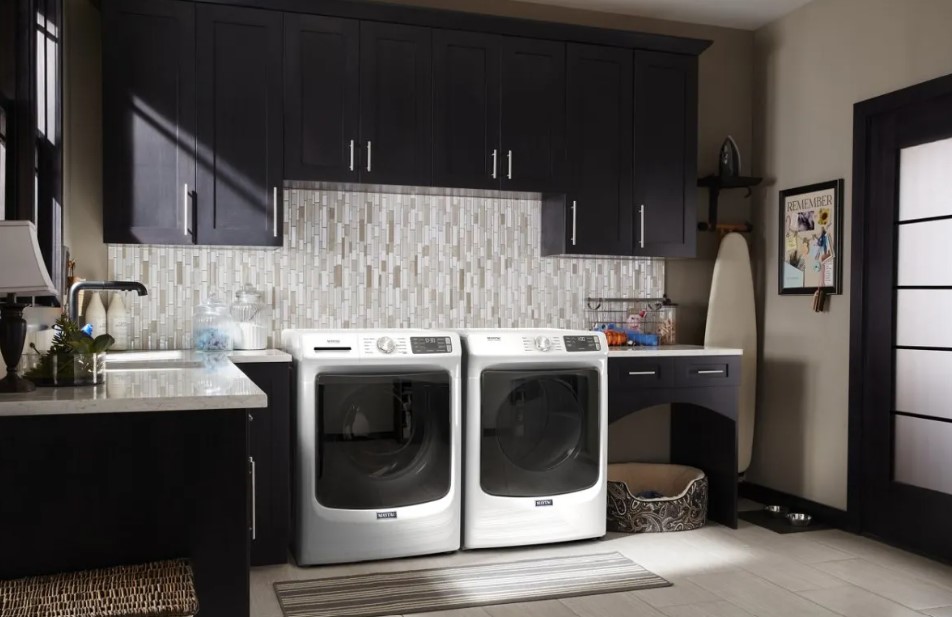 White Maytag washer and dryer in a laundry room