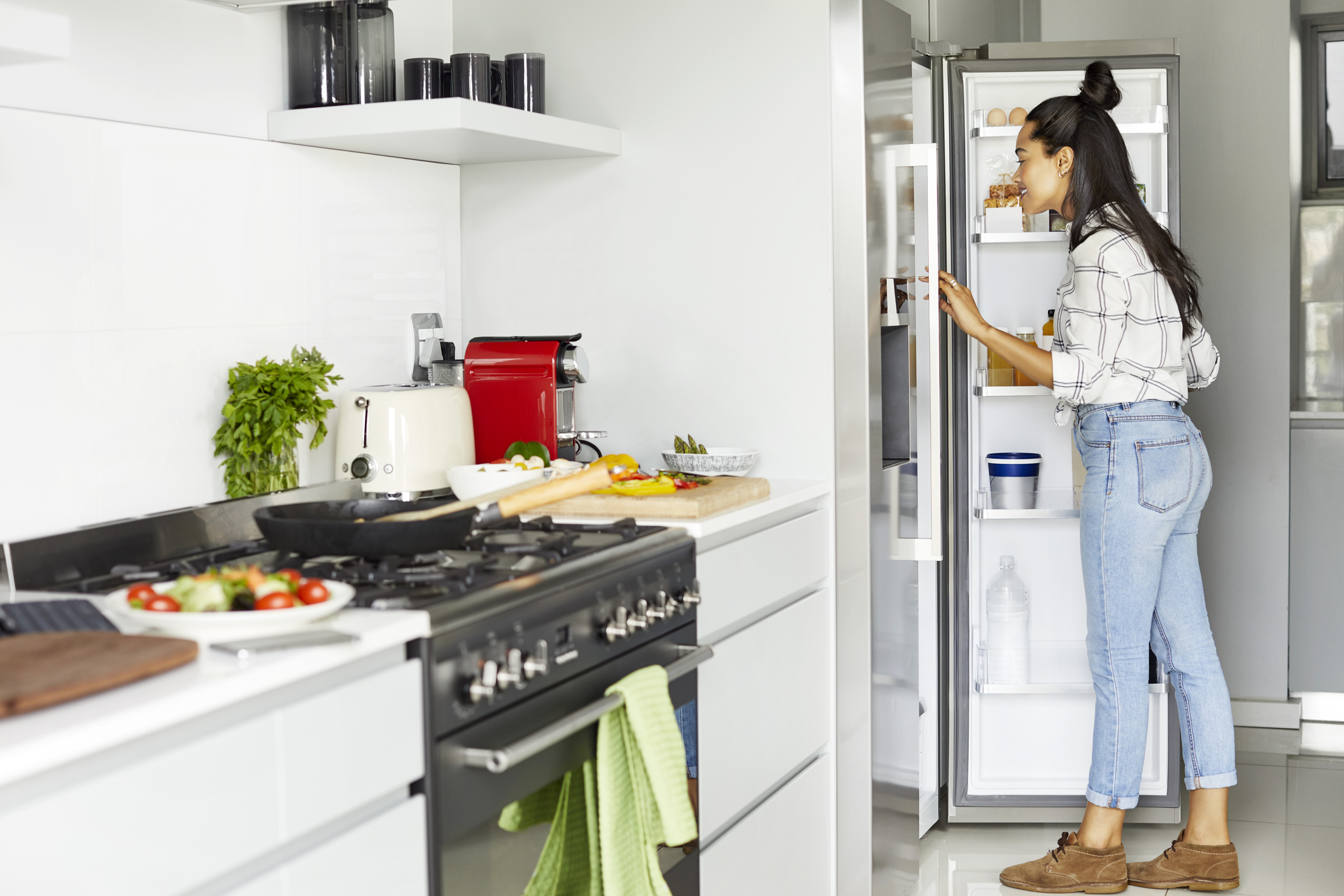 woman looking for something in the fridge