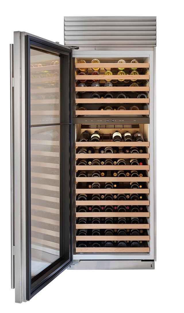 Stock photo of a Sub Zero brand wine refrigerator with the door open displaying many racks filled with wine bottles.