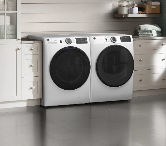 White GE front load washer and dryer in a laundry room