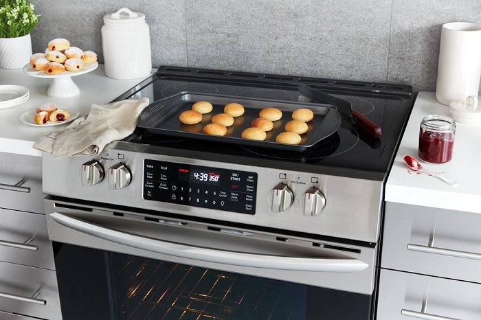 Air fried beignets on a pan atop a range with Air Fry setting