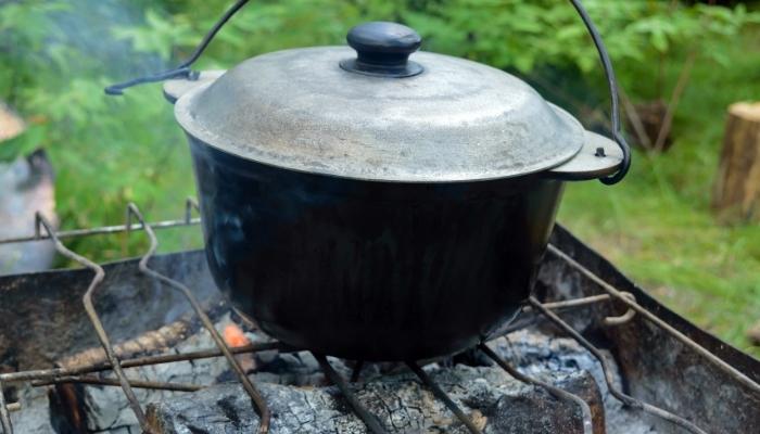 Cast iron cookware on campfire