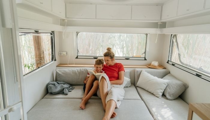mom and son relaxing in camper