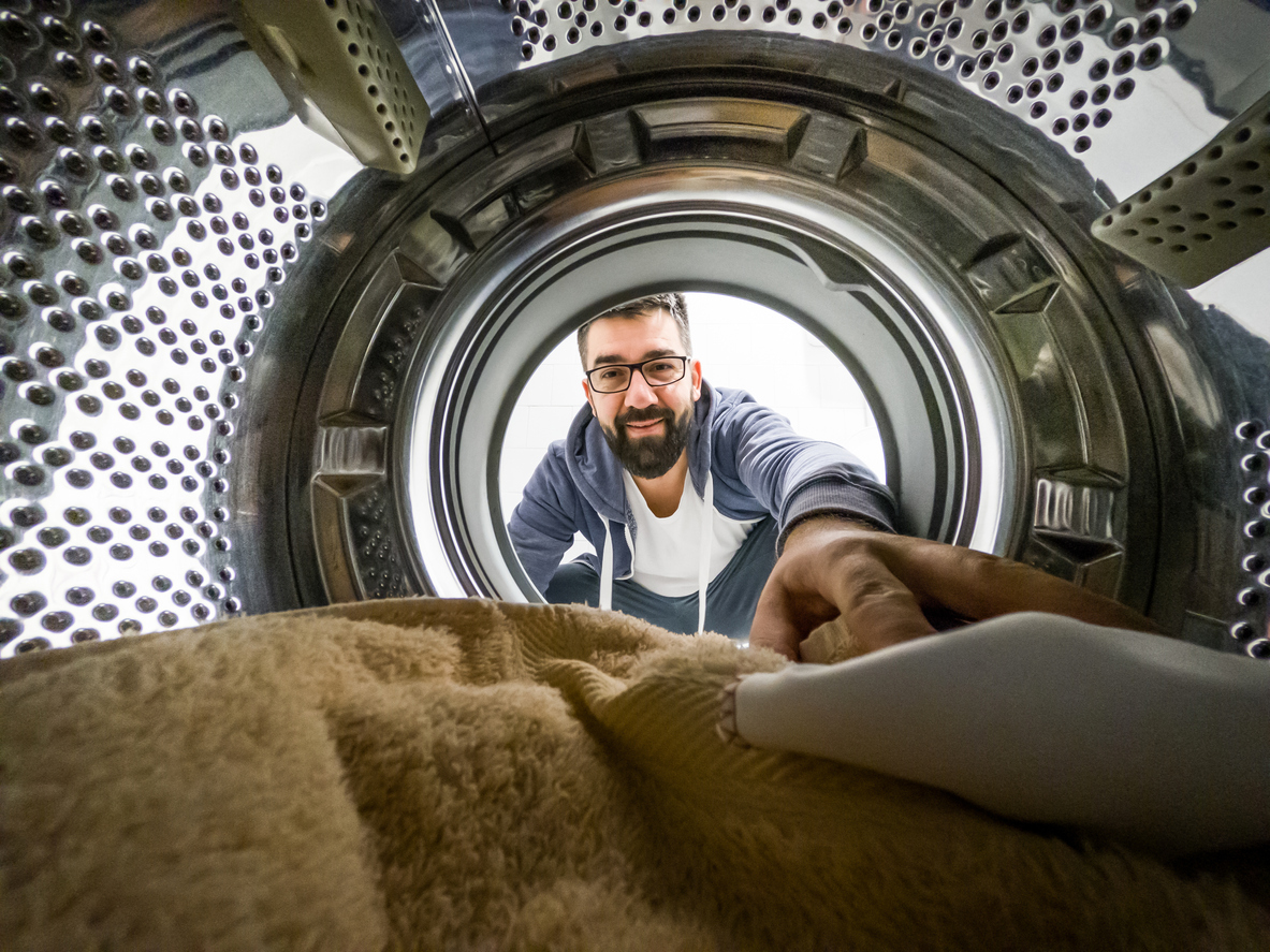 shot of towel in dryer with man