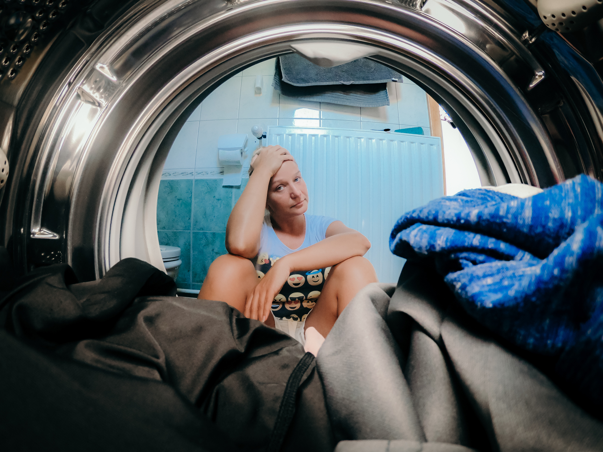 frustrated woman in front of washer