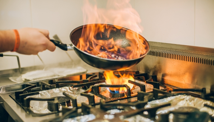 Closeup of Teflon pan on fire while cooking