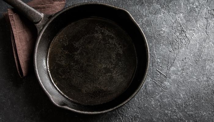 cast iron pan on black stone background