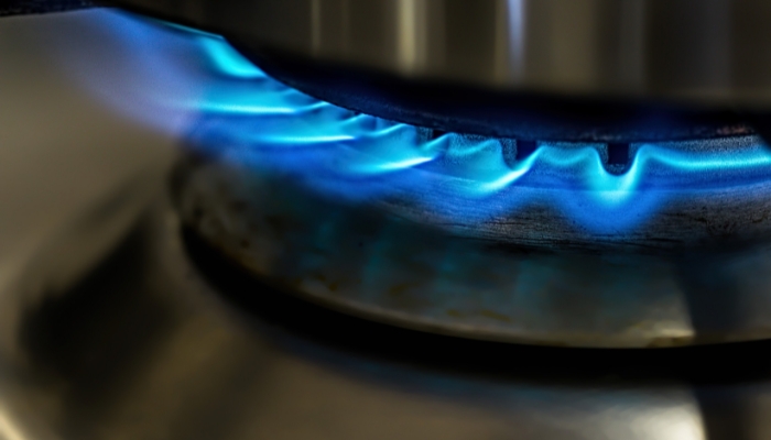 Burner on cooktop showing blue flames