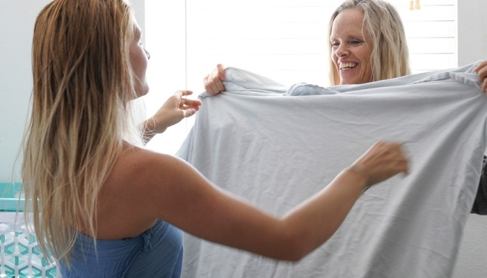 mother and daughter folding sheets