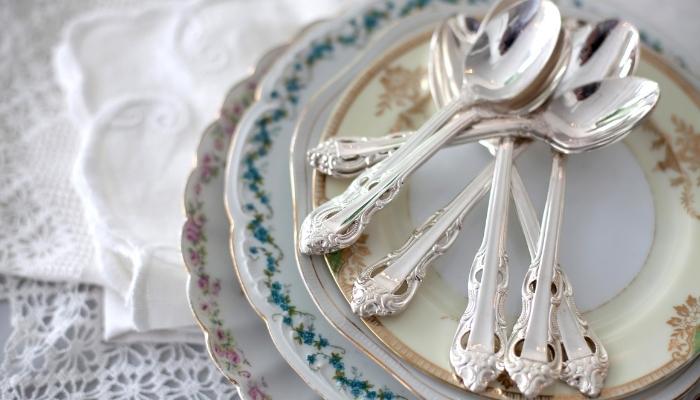 stack of vintage floral plates with silverware 