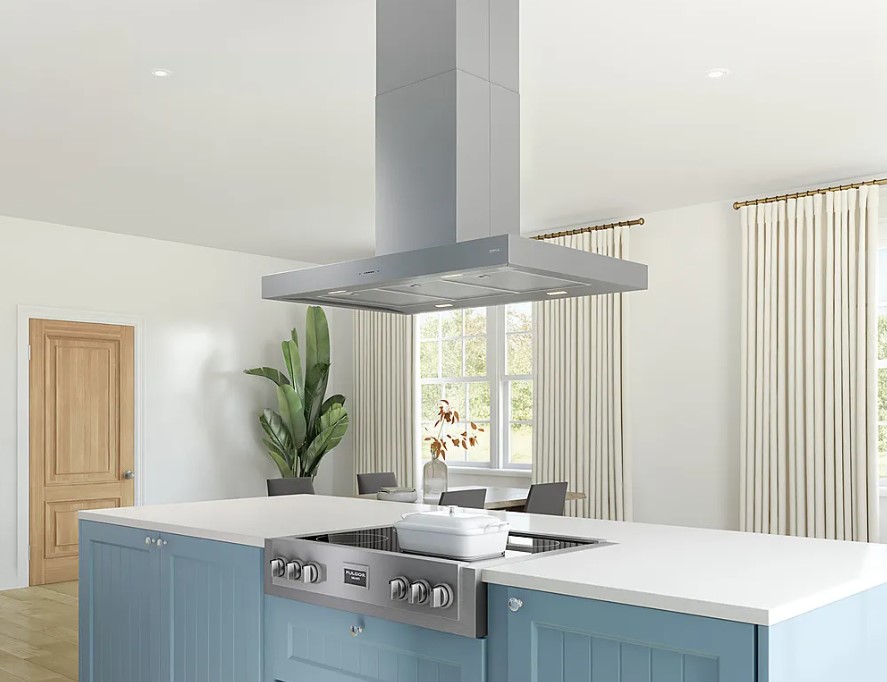 A stainless steel island range hood is positioned over a rangetop