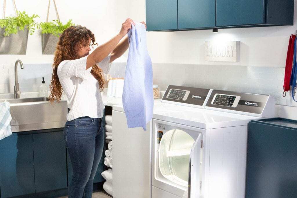 Woman using a Speed Queen dryer