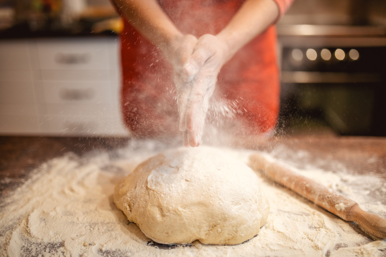 woman preparing and kneading dough for bread