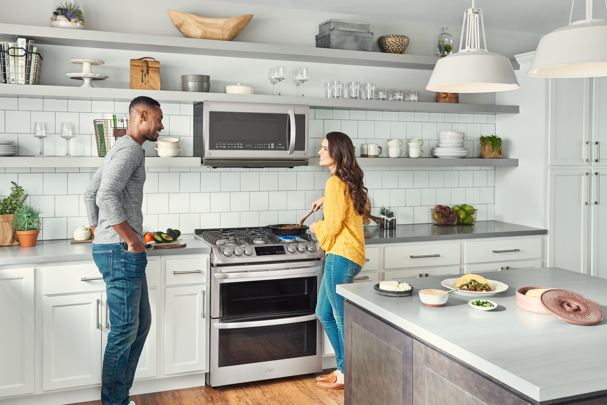 cheerful couple bond while cooking dinner on LG 30” Slide In Gas Double Oven Range