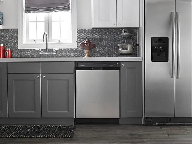 stainless steel Amana dishwasher in gray-themed kitchen