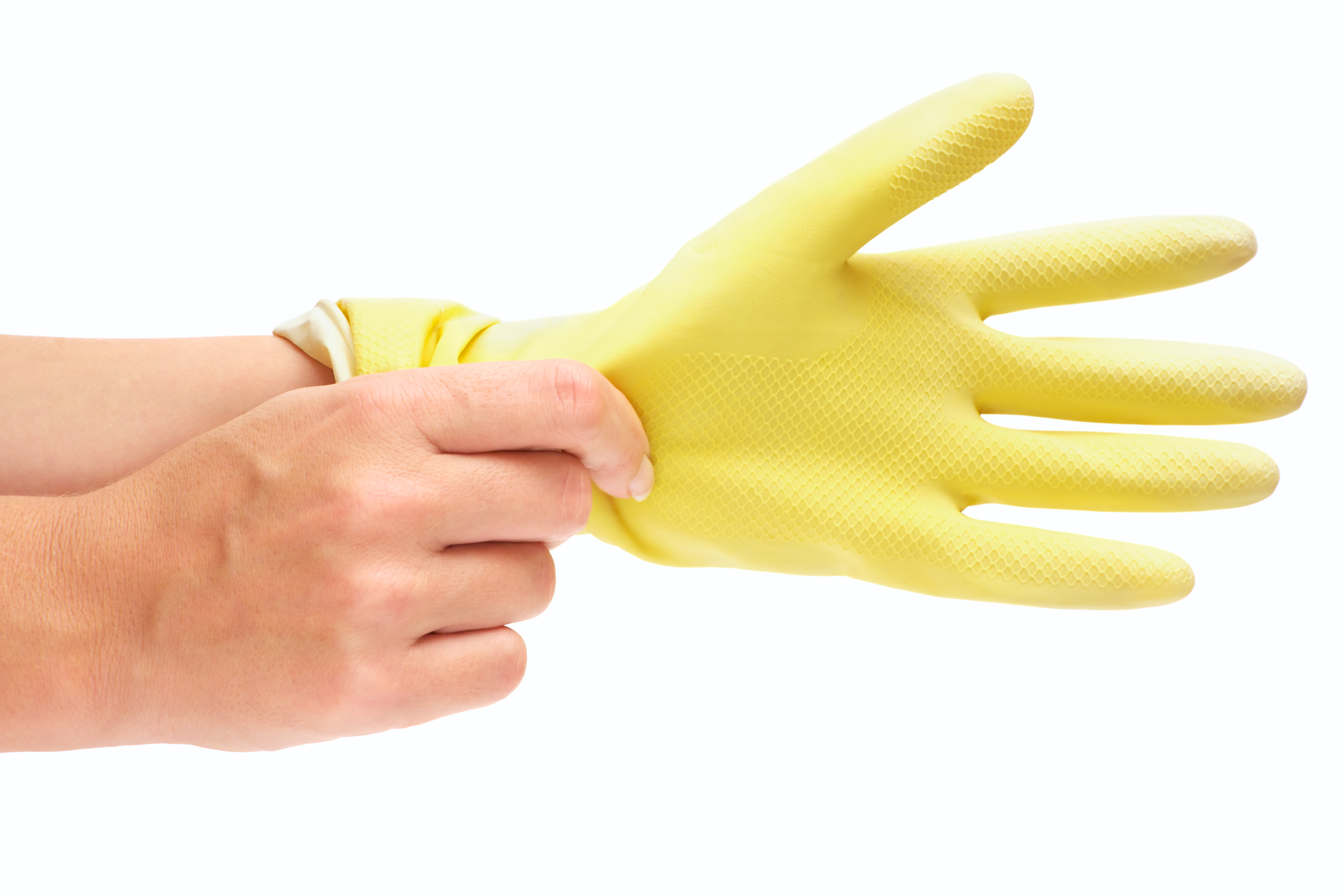 Person putting yellow rubber glove on left hand 