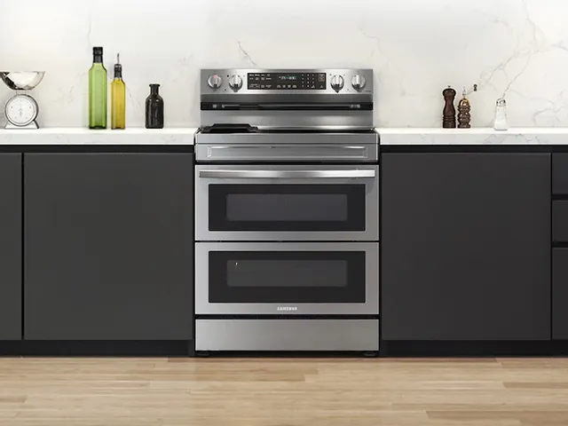 The Samsung NE63A6751SS double oven electric range in a kitchen 