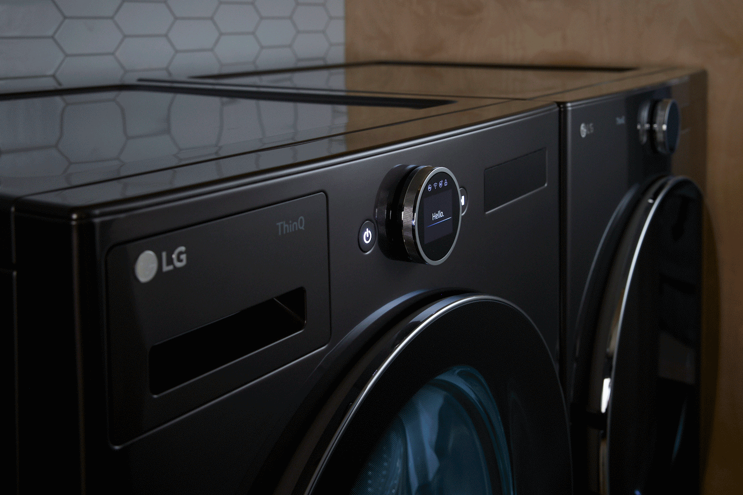 The LG WM6700HBA front load washer and LG DLEX6700B dryer in a laundry room 