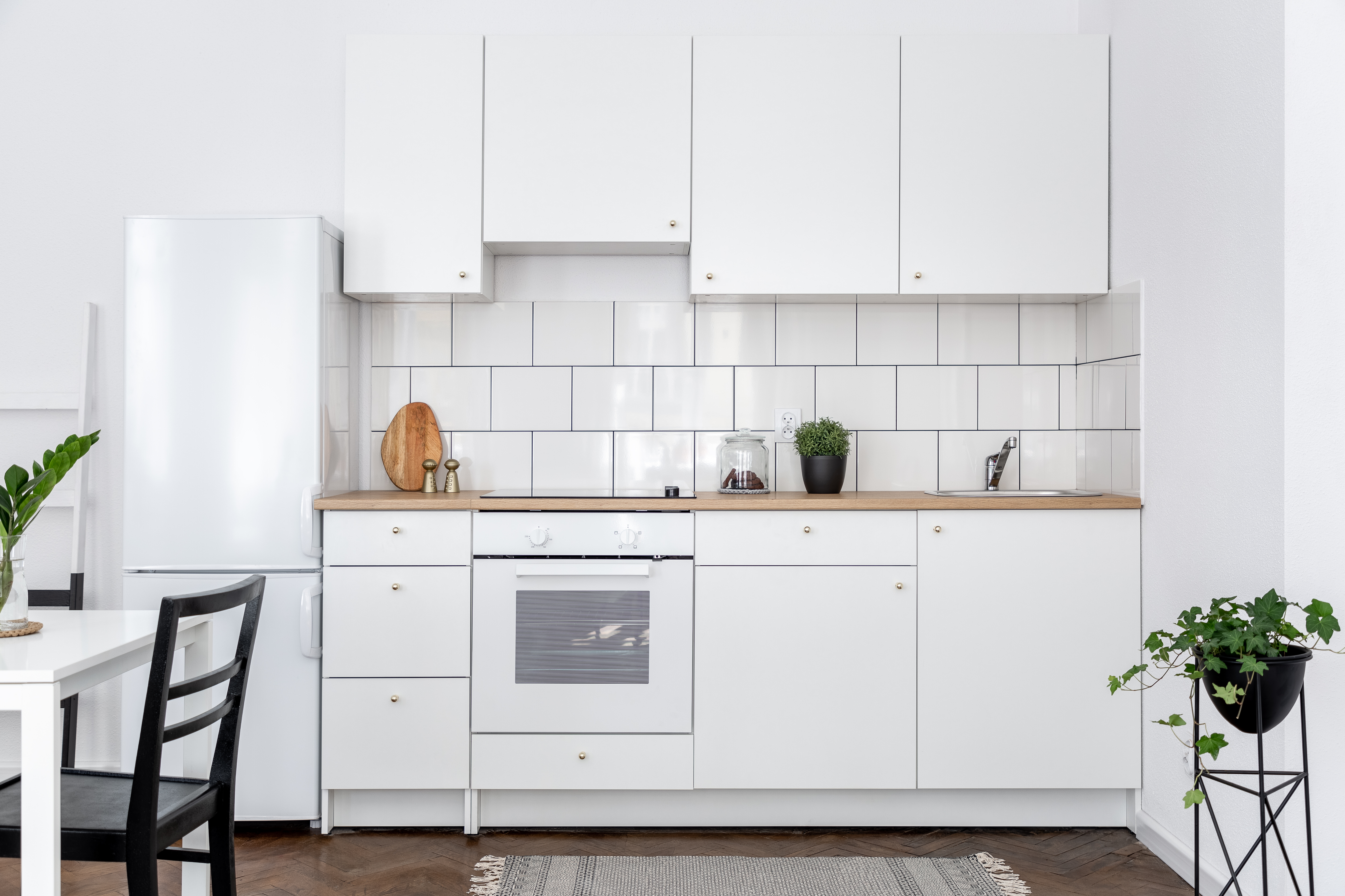 a white kitchen with white appliances