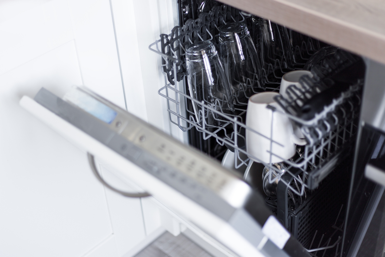 dishwasher door ajar with full top rack slightly extended 