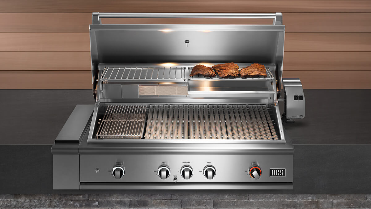 DCS BE1-48RC-N 48” gas grill with its hood open and steaks