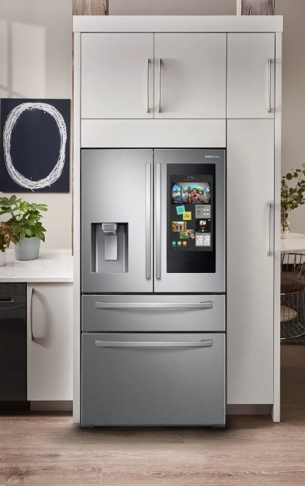 Stainless steel Samsung French door refrigerator with smart screen in a modern kitchen