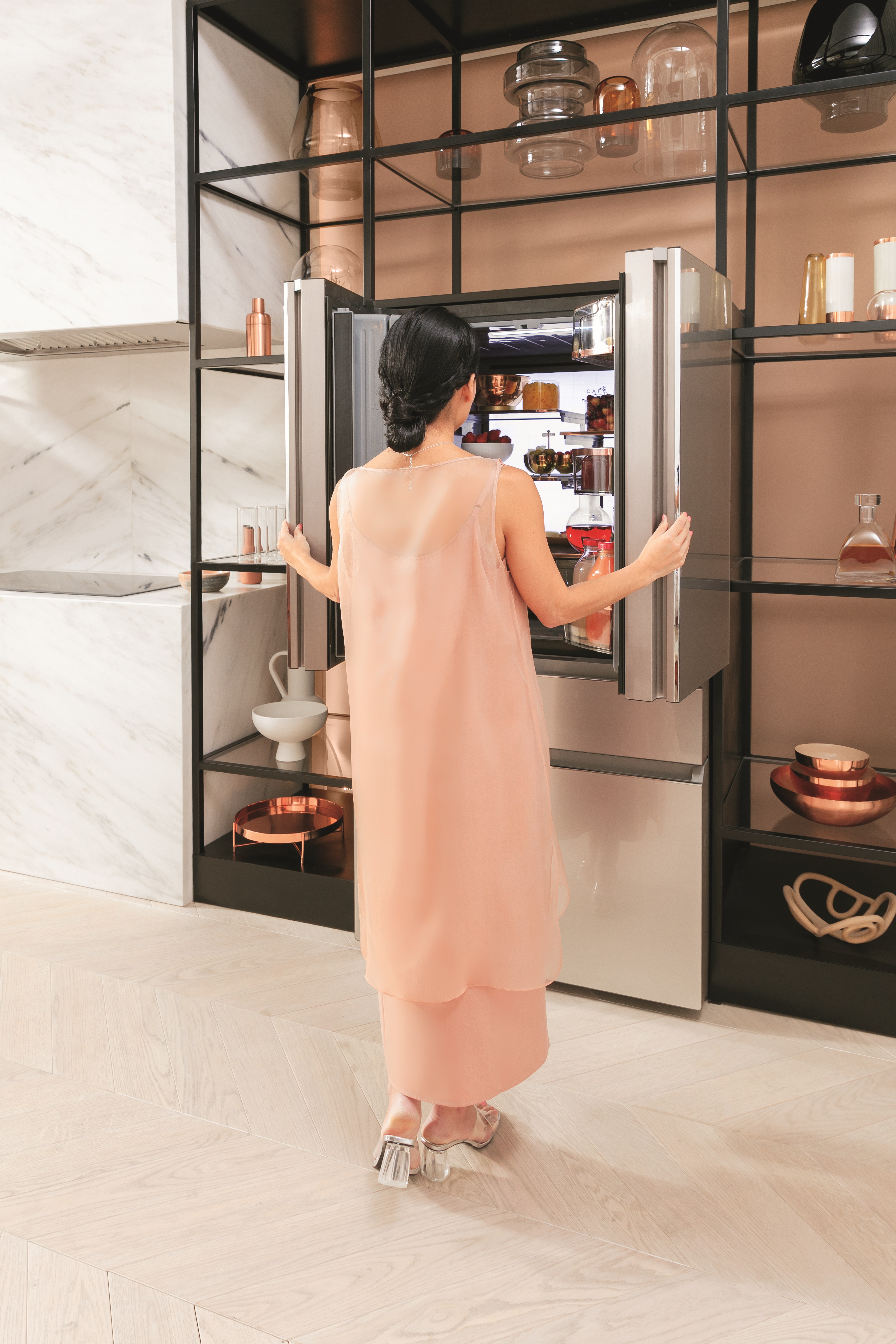 A woman using a GE Café refrigerator 