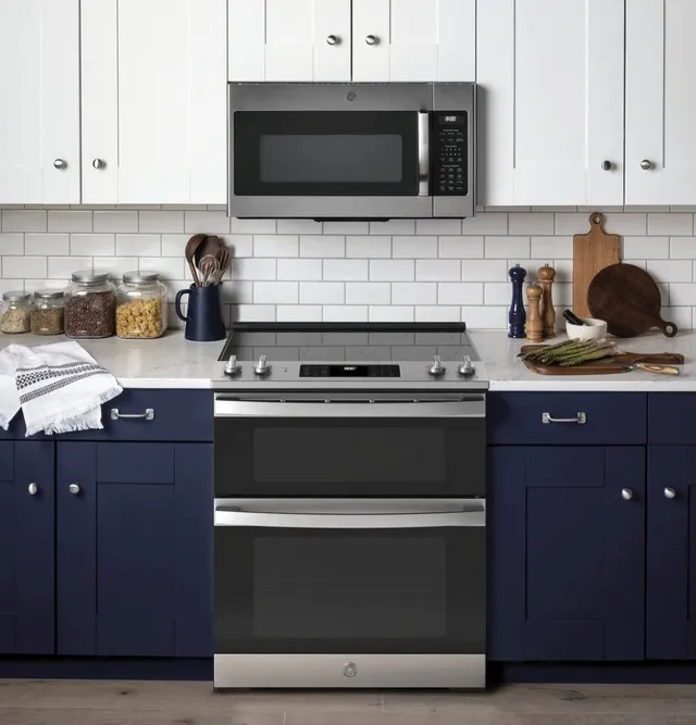 The GE JSS86SPSS slide in range in a blue and white kitchen 