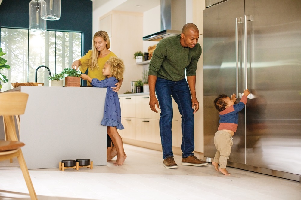 family hangs out in modern kitchen with Electrolux kitchen appliance suite 
