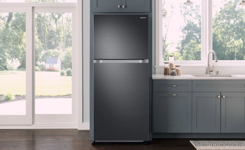 black matte top-freezer refrigerator in bare kitchen 