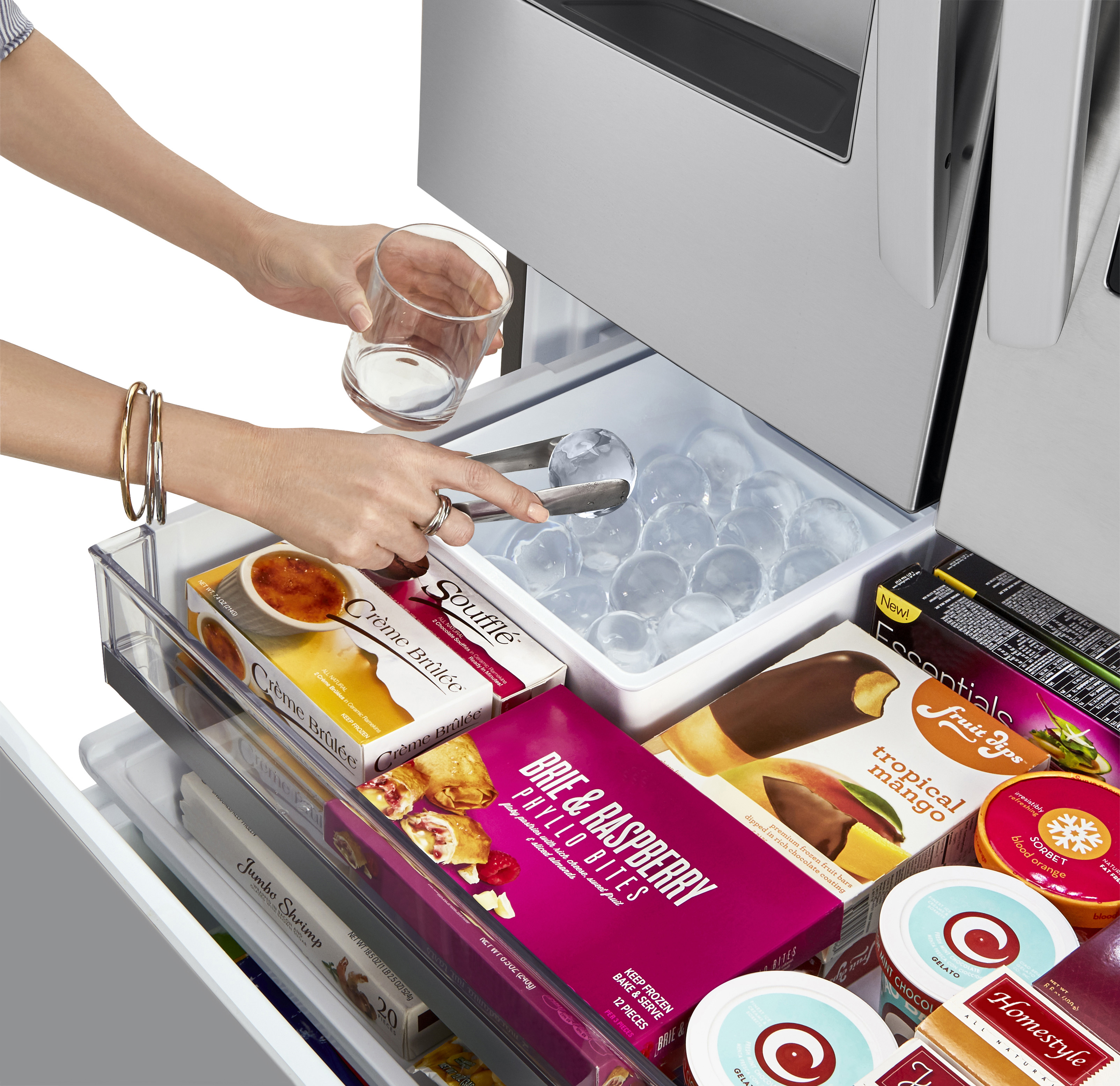 LG product image of woman using Craft Ice feature on stainless steel LRFVC2406S French door refrigerator