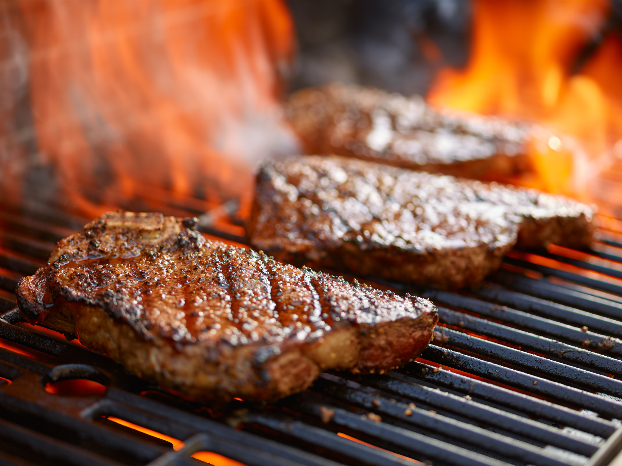close-up of steaks on the grill