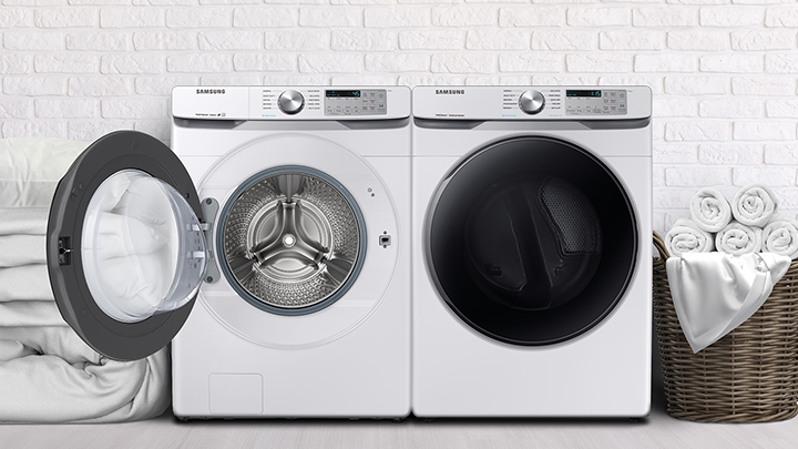 A laundry room with white brick walls and a Samsung front load washer and dryer