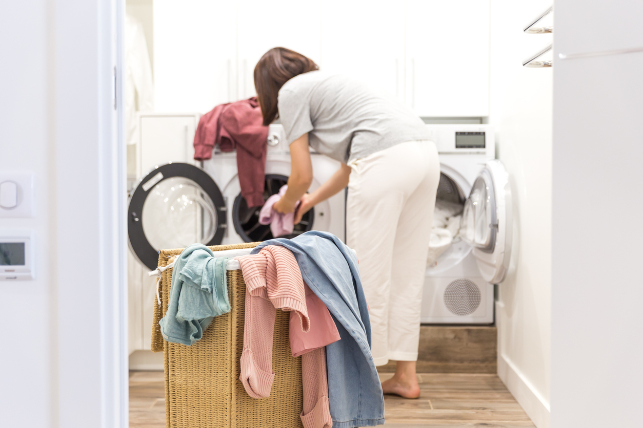 woman inspecting laundry from washer