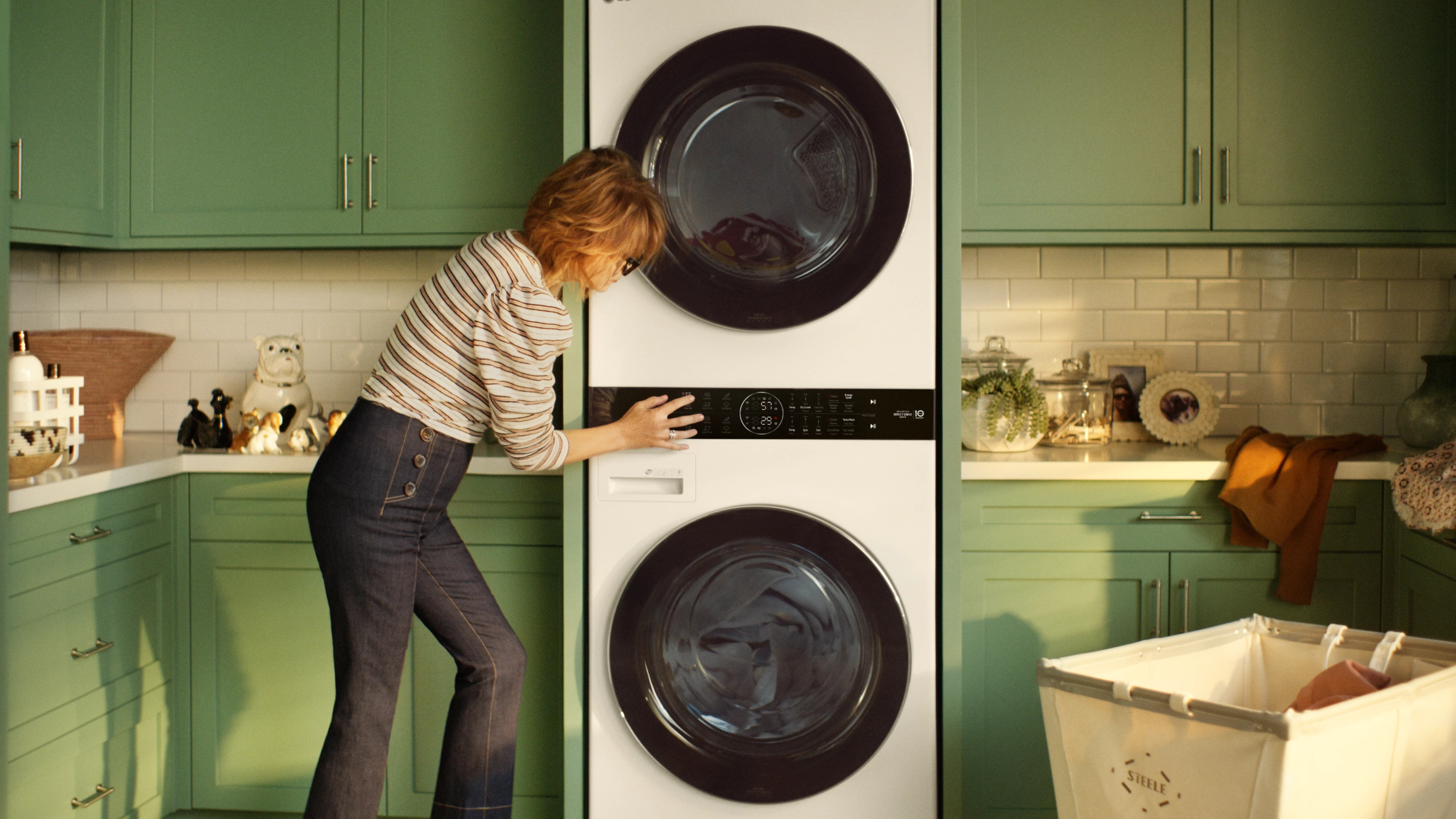 woman uses controls on LG stackable washer and dryer