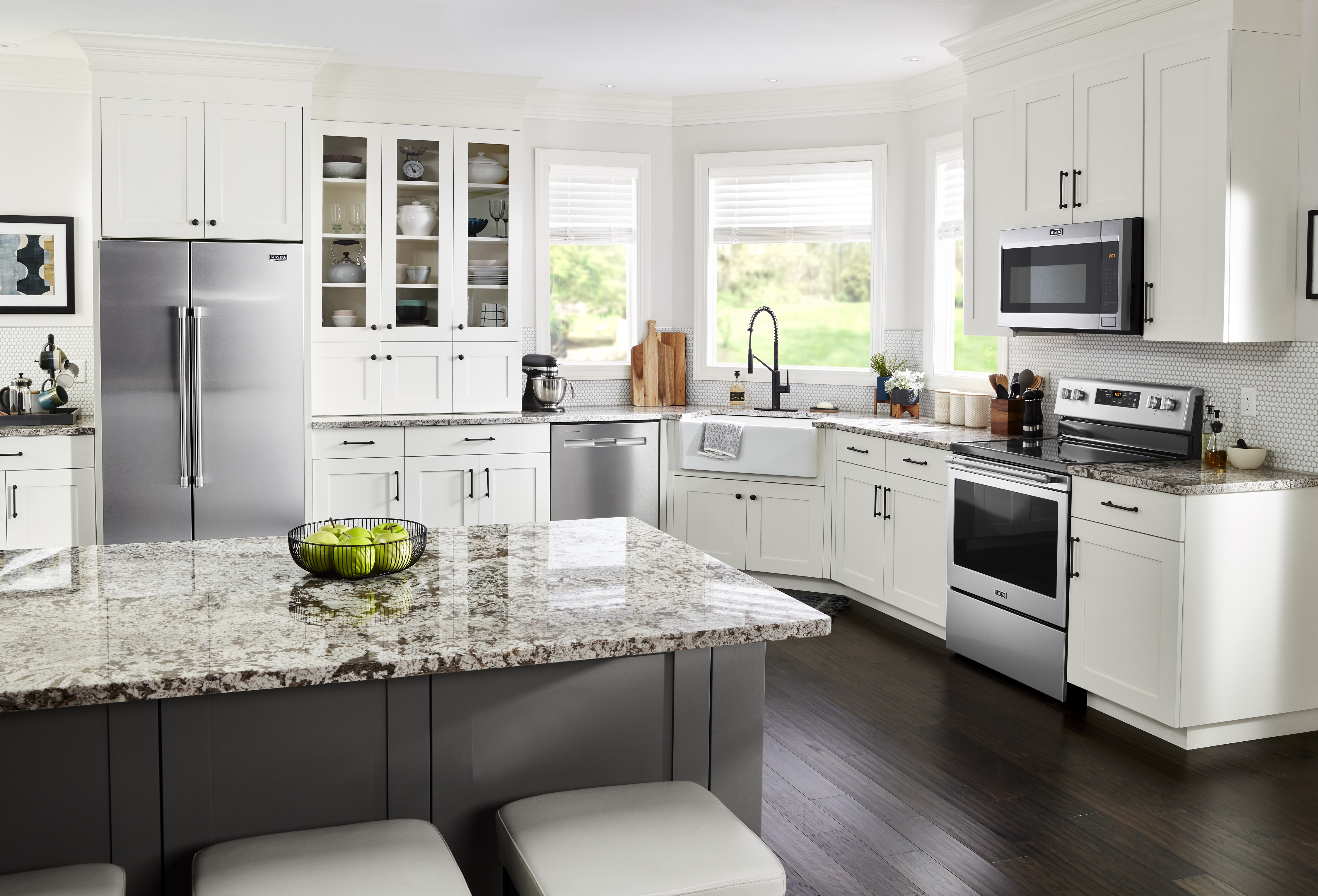 shot of kitchen with Maytag black stainless-steel appliance package