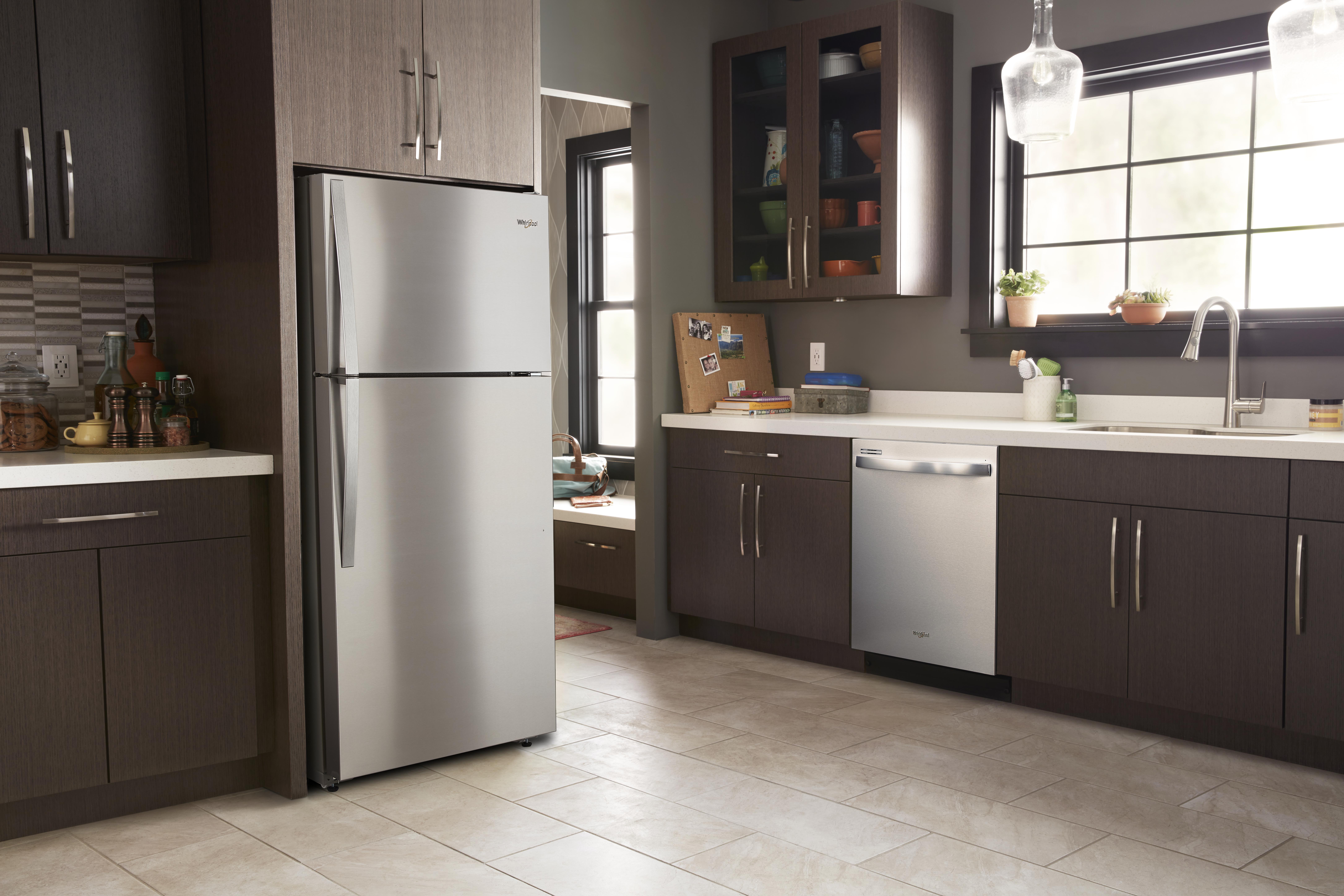 lone standard-depth Whirlpool fridge in clean, empty kitchen