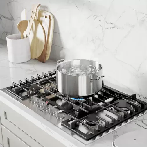 The Bosch 800 Series NGM8058UC 30” gas cooktop shown with a pot of boiling water 