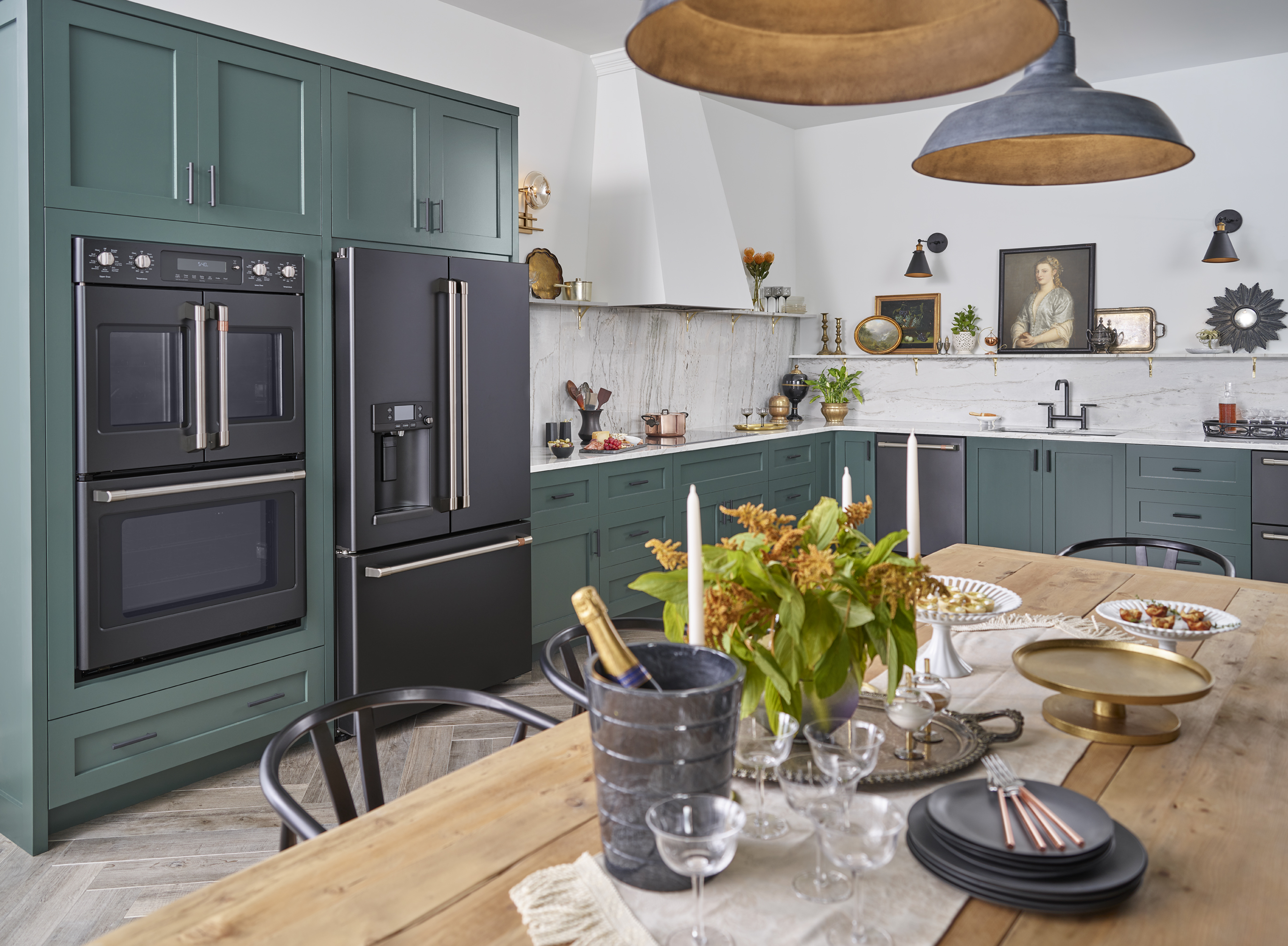 A teal-themed kitchen featuring black matte Café appliances 