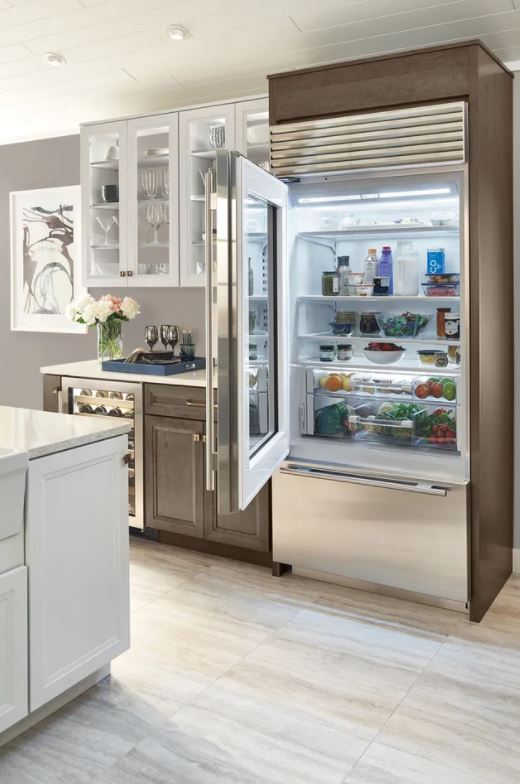 fully stocked Sub-Zero bottom freezer fridge