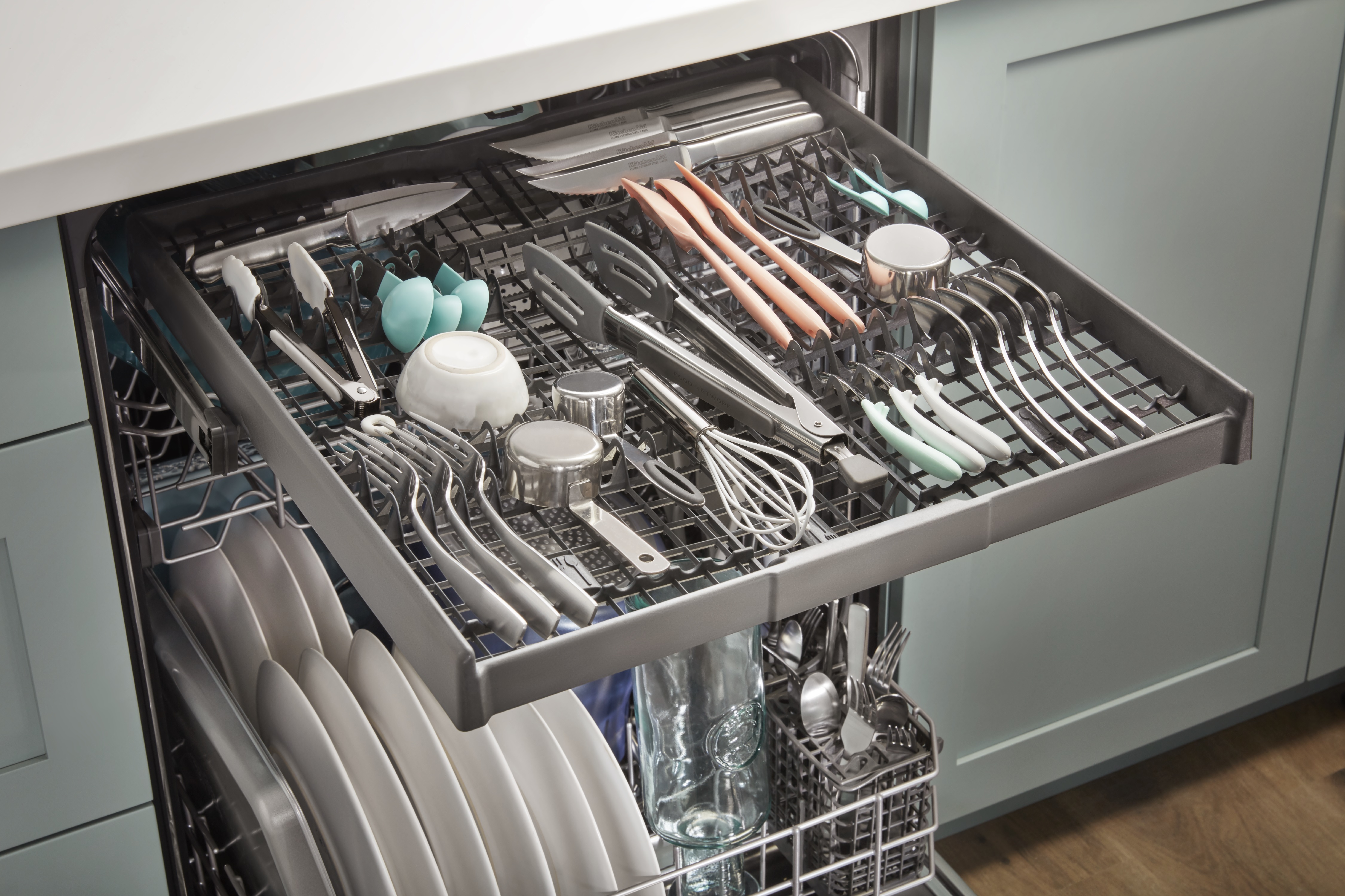 Whirlpool dishwasher reveals adjustable third rack with utensils