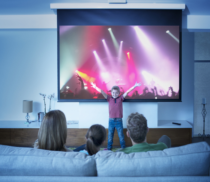 Family having movie night with their giant projector screen