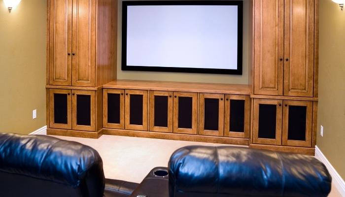 Home theater with speakers tucked away into custom cabinets