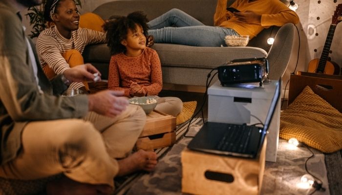 family in the living room with projector