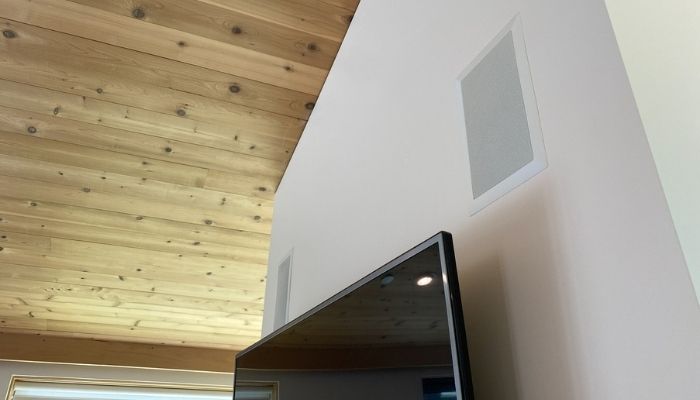 speakers mounted in wall above television