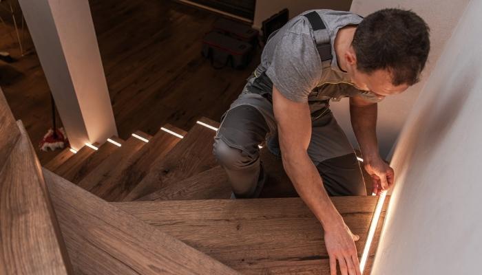 Man installing stair lights