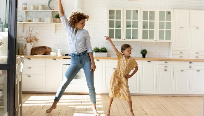 Mother and daughter dancing to tunes
