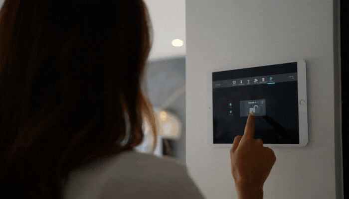 Woman uses control panel to close and lock all the doors at bedtime